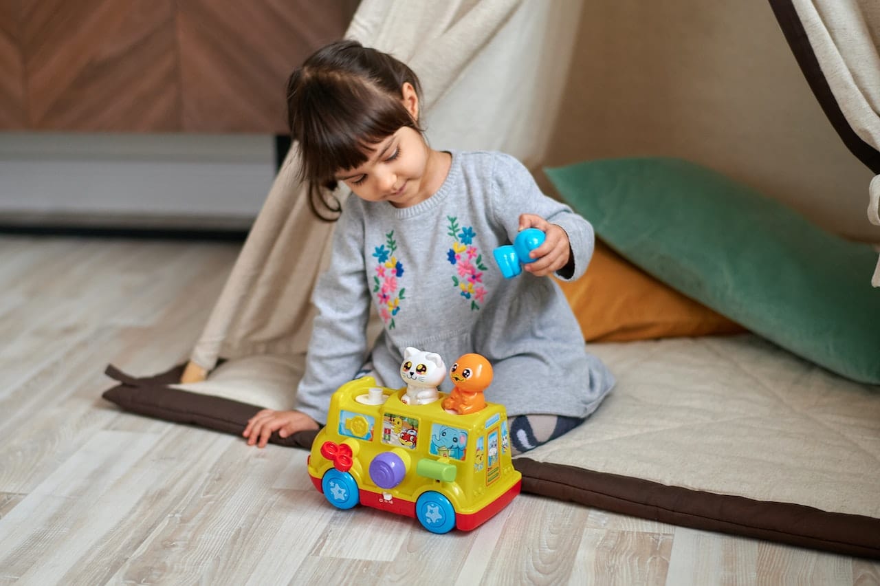 How do caregivers decide what toys to buy for infants?